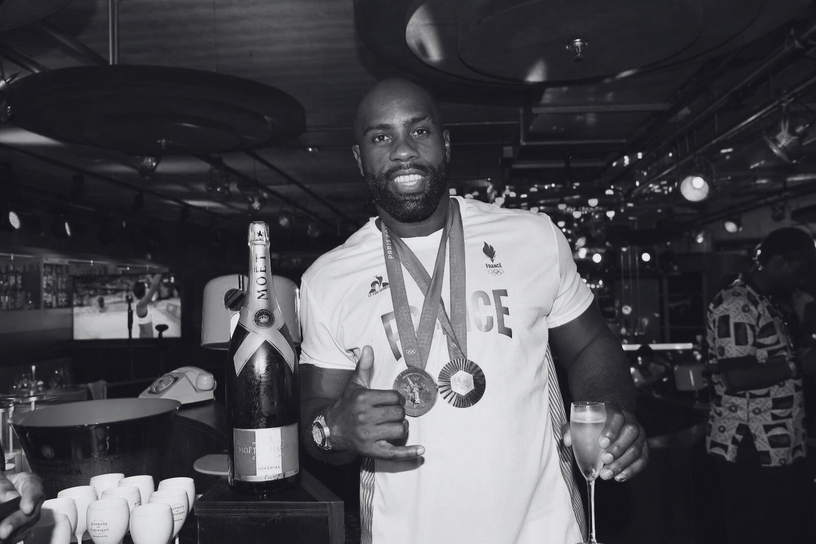 Athlete with medals and Moët